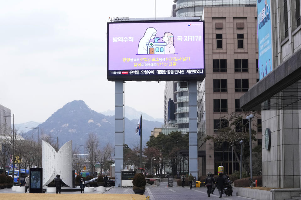 A huge electric screen showing precautions against the coronavirus is seen in Seoul, South Korea, Monday, Feb. 28, 2022. The sign reads "Follow quarantine rules." (AP Photo/Ahn Young-joon)