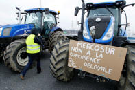 French farmers drive their tractors on the A7 highway to protest changes in underprivileged farm area’s mapping and against Mercosur talks, in Pierre-Benite near Lyon, France, February 21, 2018. Message reads "Mercosur, no to unfair competition". REUTERS/Emmanuel Foudrot