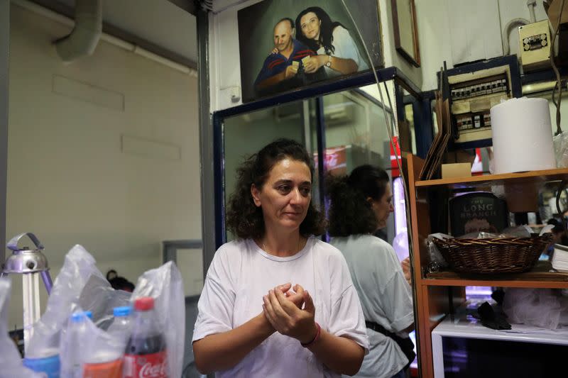 Roula Splinidou stands inside her coffee shop in Athens