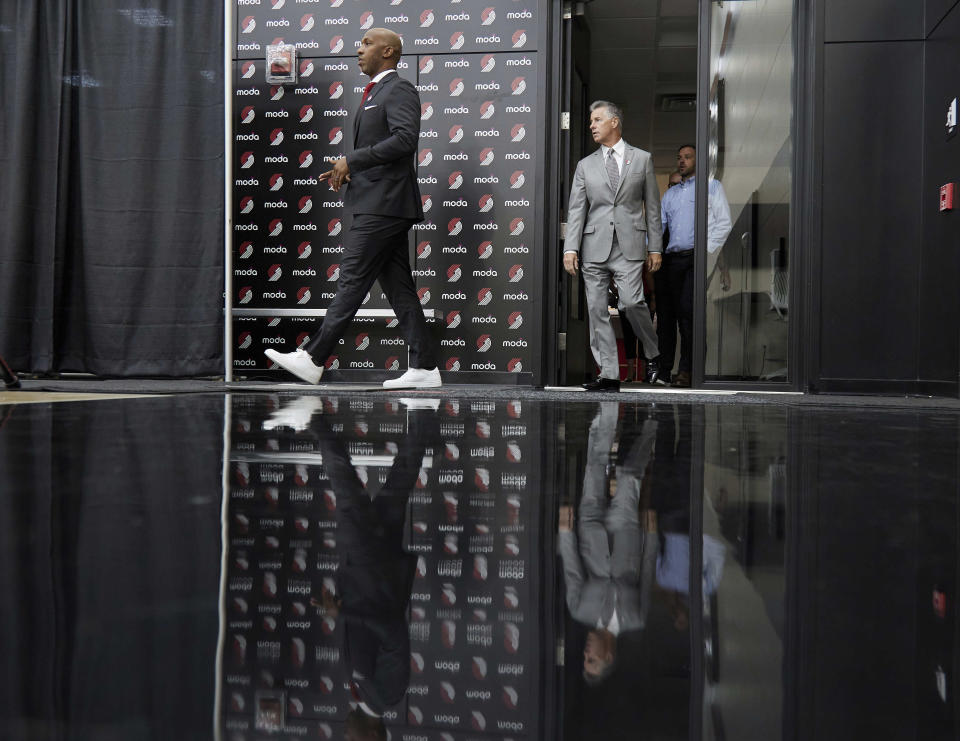 Chauncey Billups, left, and general manager Neil Olshey walk to the podium before Billups is announced as the head coach of the Portland Trail Blazers at the team's practice facility in Tualatin, Ore., Tuesday, June 29, 2021. (AP Photo/Craig Mitchelldyer)