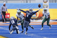 Nevada defensive back EJ Muhammad (4) reaches for the ball after it was tipped in to the air on a pass by Tulane during the first half of the Idaho Potato Bowl NCAA college football game, Tuesday, Dec. 22, 2020, in Boise, Idaho. Nevada intercepted the ball on the play. (AP Photo/Steve Conner)