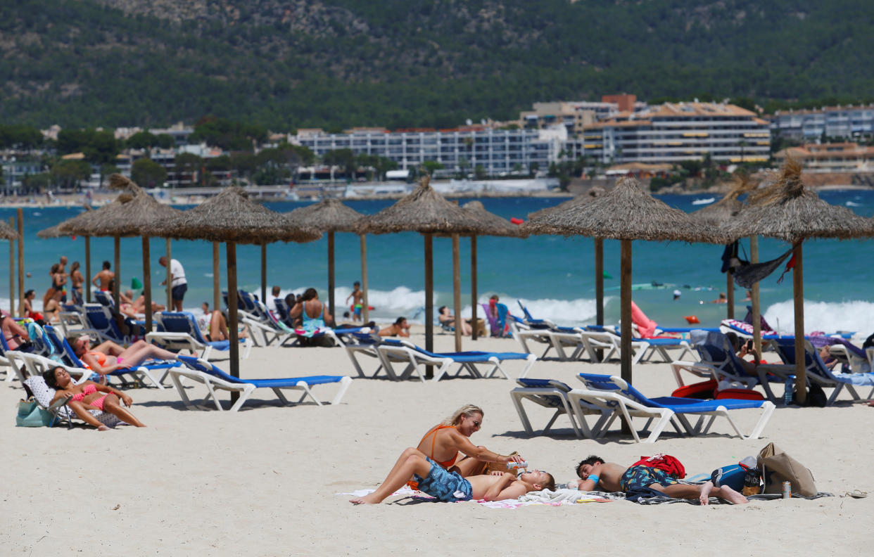 People sunbathe in Magaluf beach, amid the coronavirus disease (COVID-19) outbreak in Palma de Mallorca, Spain July 11, 2020. REUTERS/Enrique Calvo