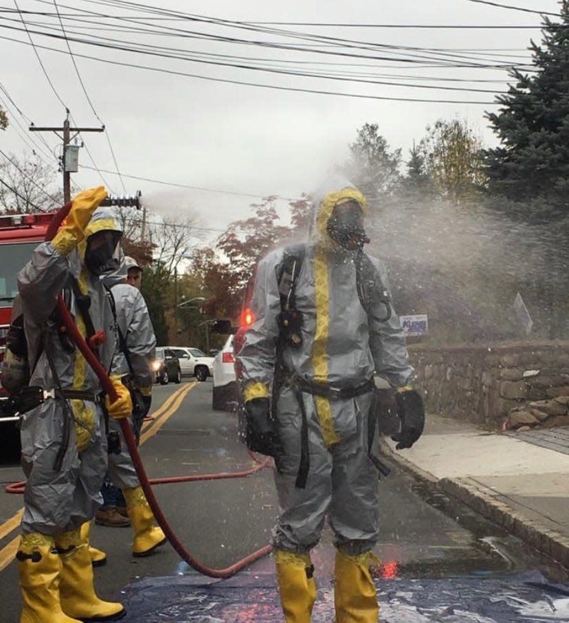 A Piermont, N.Y., first responder is decontaminated in July after an emergency call to protect against the COVID-19 virus.