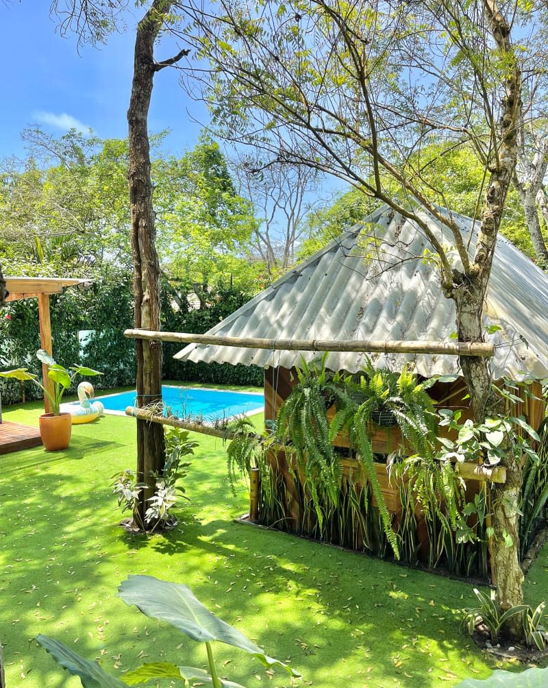 Outdoor view of bamboo structure with metal roof.