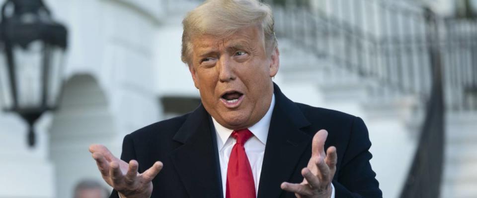 President Donald Trump talks while motioning with his hands