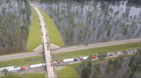 Motorists sit stranded by floodwaters on Interstate 12 in Livingston Parish, Louisiana, in this still image from video taken August 14, 2016. Louisiana State Police/Handout via REUTERS