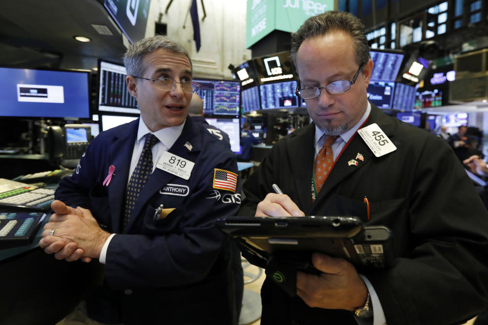 FILE- In this Friday, Nov. 9, 2018, file photo specialist Antony Rinaldi left, and trader Robert Arciero work on the floor of the New York Stock Exchange. The U.S. stock market opens at 9:30 a.m. EDT on Friday, Nov. 23. (AP Photo/Richard Drew, File)