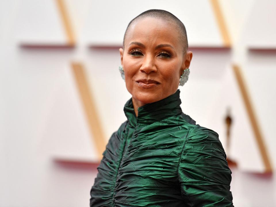 Jada Pinkett Smith smiles directly at the camera on Oscars red carpet