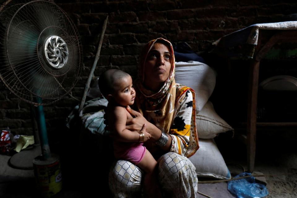 Razia, 25, and her six-month-old daughter Tamanna cool off during a heatwave in Jacobabad, Pakistan (Reuters)