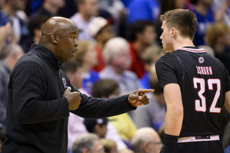 Omaha head coach Chris Crutchfield talks to guard Tony Osburn (32) during the first half of an NCAA college basketball game against Kansas in Lawrence, Kan., Monday, Nov. 7, 2022. (AP Photo/Reed Hoffmann)