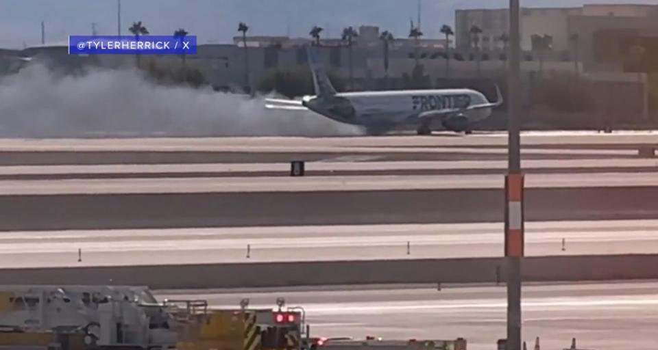 Flames and smoke were seen coming from a plane that made a hard landing at Harry Reid International Airport in Las Vegas on Saturday afternoon. (Courtesy of @Tylerherrick)