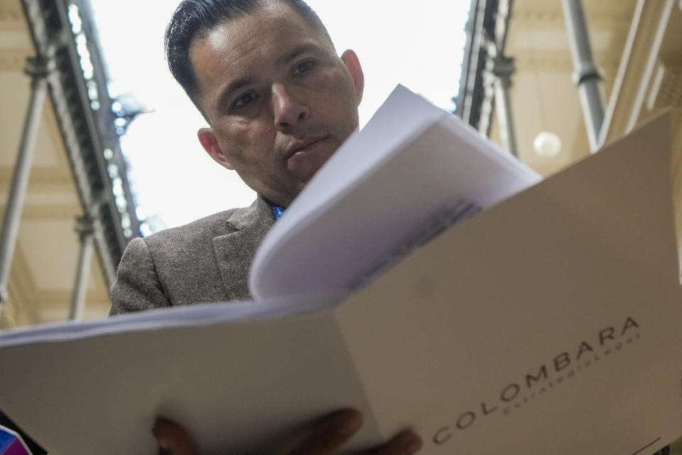 Born in Chile and adopted in the U.S., Marine Jimmy Lippert Thyden González reviews documents in the Supreme Court after presenting a criminal complaint against the Chilean government for child abduction, a widespread practice that spanned decades, in Santiago, Chile, Monday, July 1, 2024. Thyden González discovered more than a year prior that he was stolen at birth during the Augusto Pinochet regime. (AP Photo/Esteban Felix)