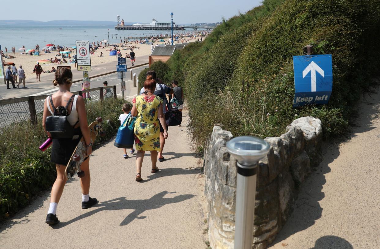 People make their way down towards Bournemouth beach in Dorset: PA