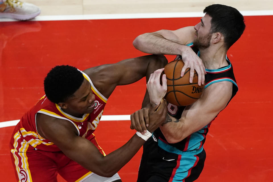 Atlanta Hawks forward Nathan Knight (1) and Memphis Grizzlies guard John Konchar (46) struggle for control of the ball in the second half of an NBA basketball game Wednesday, April 7, 2021, in Atlanta. (AP Photo/John Bazemore)