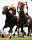 <p>Damien Oliver riding Pop Rock (L) to victory during the Melbourne Cup.</p>