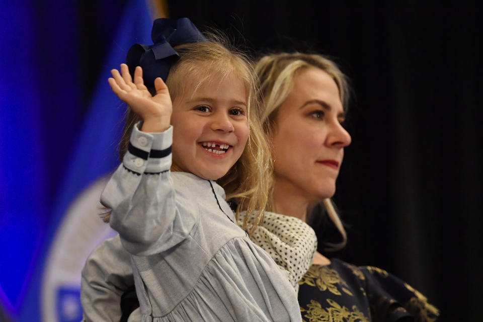 Four-year-old Greta McGarvey waves to the crowd as her mother, Chris, holds her during Morgan McGarvey's victory speech in Louisville, Ky., Tuesday, Nov. 8, 2022. McGarvey won in the state's 3rd Congressional District. (AP Photo/Timothy D. Easley)