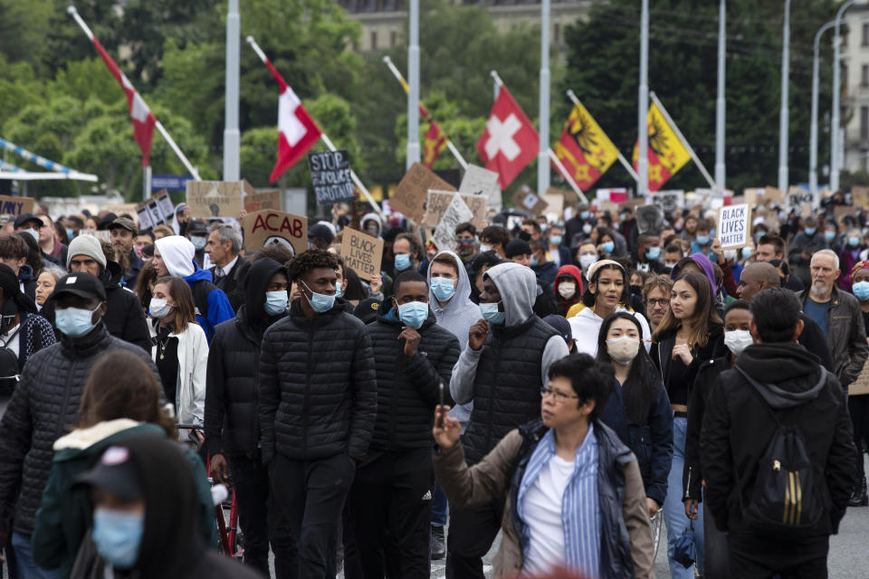 Several thousand demonstrators take part in an anti-racism demonstration, against police violence and in memory of George Floyd, during a Black Lives Matter (BLM) protest, in Geneva, Switzerland, Tuesday, June 9, 2020. Floyd, a black man, died after he was restrained by Minneapolis police on May 25, igniting protests in the U.S., and globally. (Salvatore Di Nolfi/Keystone via AP)