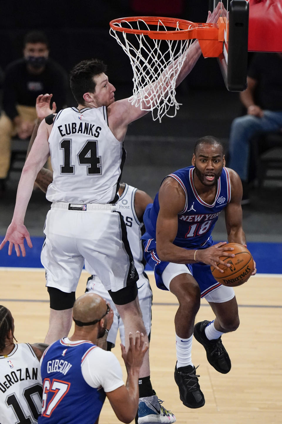 New York Knicks' Alec Burks (18) passes away from San Antonio Spurs' Drew Eubanks (14) during the second half of an NBA basketball game Thursday, May 13, 2021, in New York. (AP Photo/Frank Franklin II, Pool)