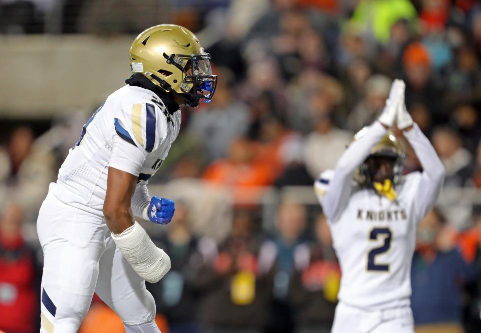 Hoban's Cartier Williams, left, celebrates after helping Tanner Mintz bring down Massillon QB DaOne Owens in the end zone for a second-quarter safety.