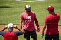 Washington Nationals' Adam Eaton (2), center, speaks with a staff member as the team holds its first baseball training camp workout at Nationals Stadium, Friday, July 3, 2020, in Washington. (AP Photo/Andrew Harnik)