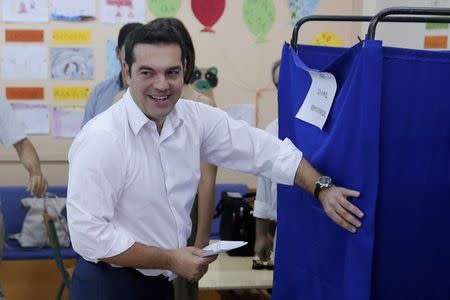 Former Greek prime minister and leader of leftist Syriza party Alexis Tsipras holds his ballot as he enters the polling booth before voting for the general elections at a polling station in Athens, Greece, September 20, 2015. REUTERS/Alkis Konstantinidis