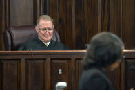 Superior Court Judge Timothy Walmsley listens to an attorney for the prosecution question potential juror during jury selection for the trial of Greg and Travis McMichael and William "Roddie" Bryan, at the Glynn County Courthouse, Monday, Oct. 25, 2021, in Brunswick, Ga. The trio are charged with the slaying of 25-year-old Ahmaud Arbery in February 2020. (AP Photo/Stephen B. Morton, Pool)