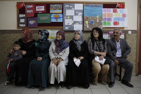 People wait to cast their ballots at a polling station during the parliamentary election in Konya, Turkey, June 7, 2015. REUTERS/Umit Bektas