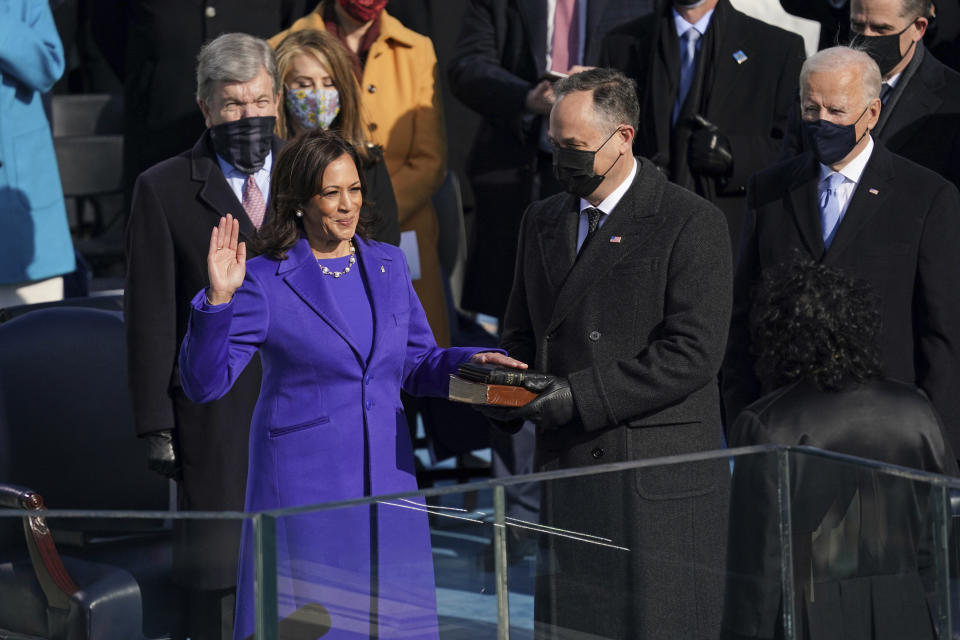 FILE - Kamala Harris is sworn in as vice president by Supreme Court Justice Sonia Sotomayor as her husband Doug Emhoff holds the Bible during the 59th Presidential Inauguration at the U.S. Capitol in Washington, Wednesday, Jan. 20, 2021. On Friday, Jan. 22, The Associated Press reported on stories circulating online incorrectly claiming Kamala Harris put her hand on a purse instead of a Bible during her swearing in. (Erin Schaff/The New York Times via AP, Pool, File)