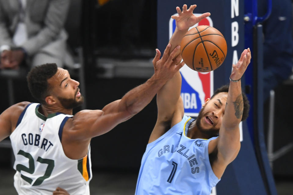 Memphis Grizzlies forward Kyle Anderson (1) and Utah Jazz center Rudy Gobert (27) vie for a rebound during the first half of Game 3 of an NBA basketball first-round playoff series Saturday, May 29, 2021, in Memphis, Tenn. (AP Photo/John Amis)