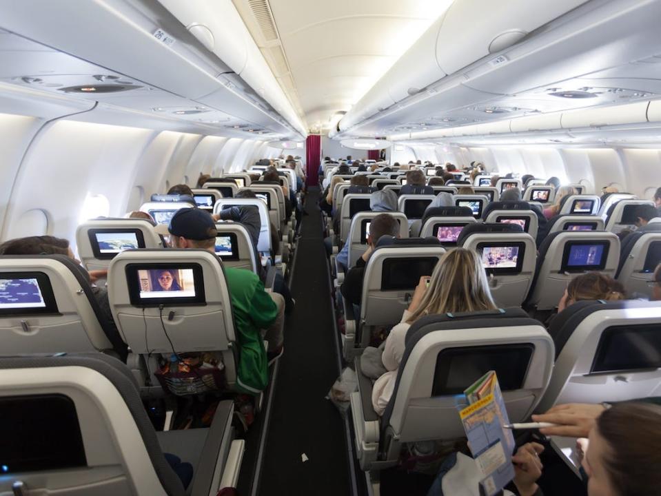 A view of an airplane cabin from the back.