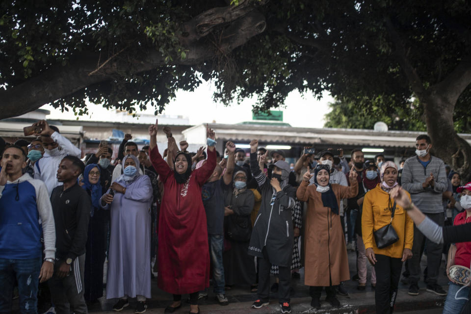 Protesters shouts slogans during a demonstration against the government enforcing of a mandatory COVID-19 vaccine pass, in Rabat, Morocco, Sunday, Oct. 31, 2021. (AP Photo/Mosa'ab Elshamy)