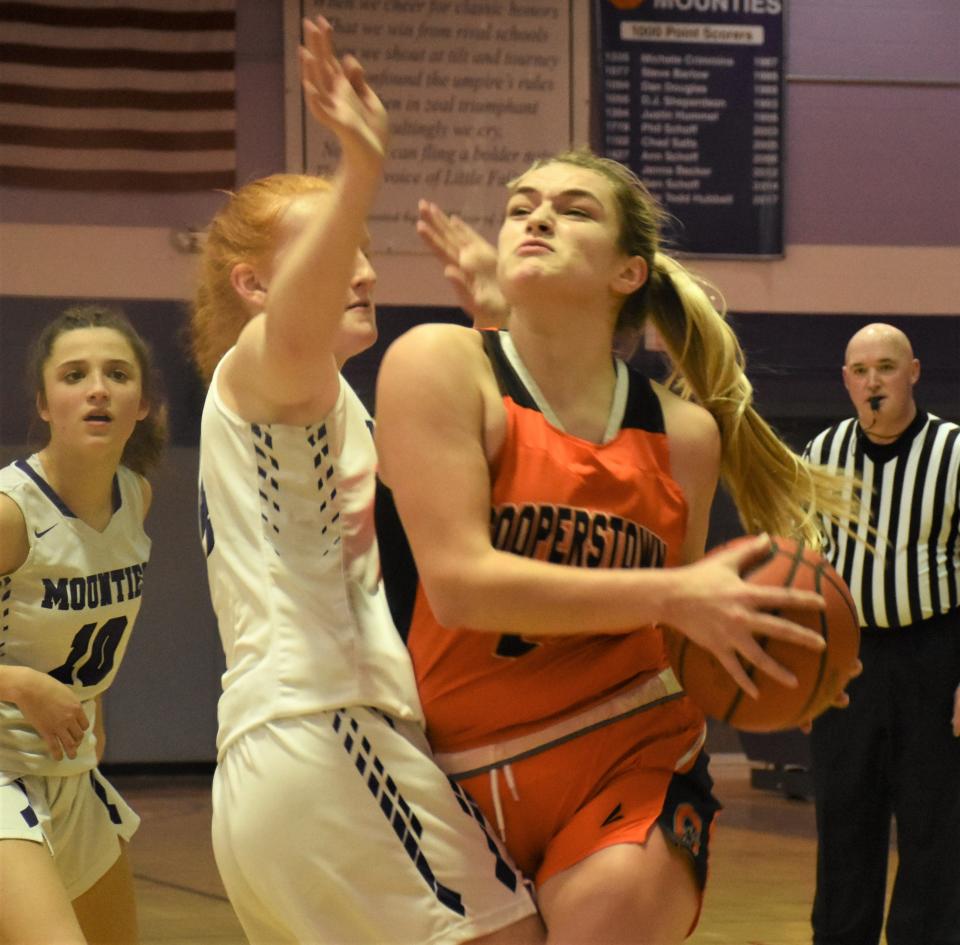 Cooperstown Hawkeye Dani Seamon (right) drives to the basket with Alexis Kress defending for Little Falls during the first half Thursday. Seamn scored a career-high 30 points as Cooperstown earned its second one-point win over Little Falls this season.