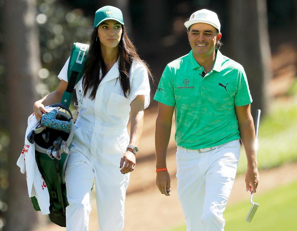 Rickie Fowler of the United States walks with fiancee Allison Stokke during the Par 3 Contest prior to the Masters at Augusta National Golf Club on April 10, 2019 in Augusta, Georgia