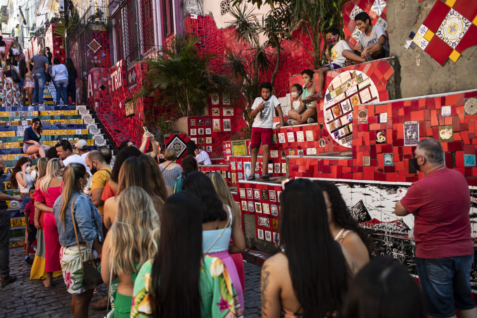 People line up to take their pictures on the Selaron Stairway in Rio de Janeiro, Brazil, Friday, July 23, 2021, during the COVID-19 pandemic. (AP Photo/Bruna Prado)