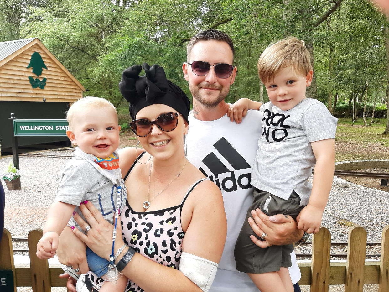 Amy Palmer discovered a lump while breastfeeding, pictured with her husband Colin and two young children Lenny, now one, and Frankie, four. (SWNS)
