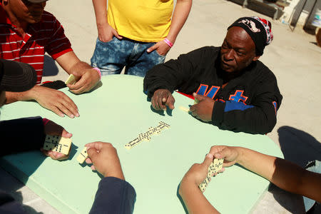 Cuban migrants, waiting for their appointment to request asylum in the U.S., play dominoes at a church being used as a shelter in Ciudad Juarez, Mexico, February 25, 2019. REUTERS/Jose Luis Gonzalez