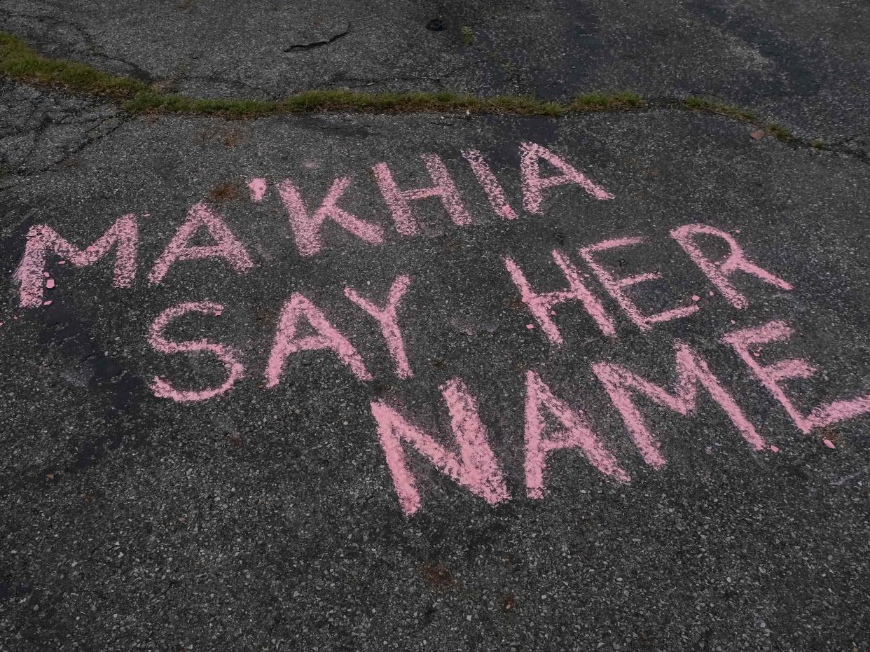 <p>Supporters write messages in chalk at a vigil in Columbus, Ohio on 21 April 2021 in memory of MaKhia Bryant, 16, who was shot and killed by a Columbus Police Department officer</p> ((AFP via Getty Images))