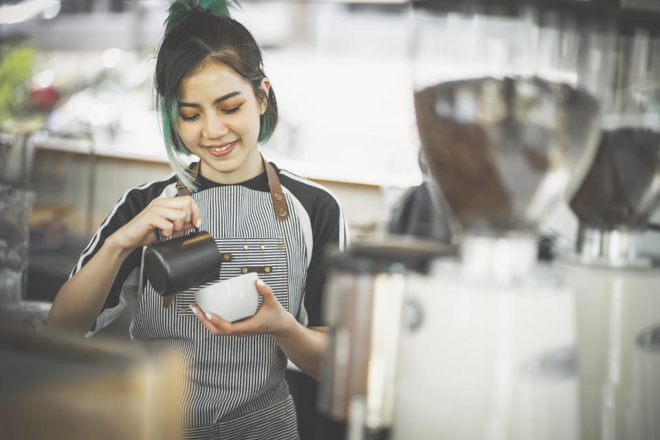 Barista woman making coffee in the coffee shop