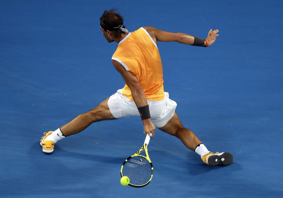 Spain's Rafael Nadal makes a backhand return to Australia's Alex de Minaur during their third round match at the Australian Open tennis championships in Melbourne, Australia, Friday, Jan. 18, 2019. (AP Photo/Kin Cheung)