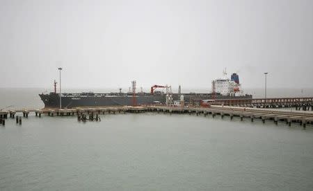 A vessel being loaded with petroleum products from the Vadinar refinery, operated by Essar Oil Ltd., (EOL) is pictured off jetty Essar ports in Gujarat June 6, 2012. REUTERS/Amit Dave/Files