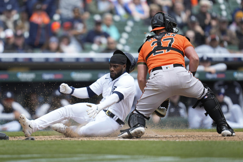 Detroit Tigers' Akil Baddoo slides safely into home plate as Baltimore Orioles catcher James McCann (27) waits for the throw in the seventh inning during the first baseball game of a doubleheader, Saturday, April 29, 2023, in Detroit. (AP Photo/Paul Sancya)