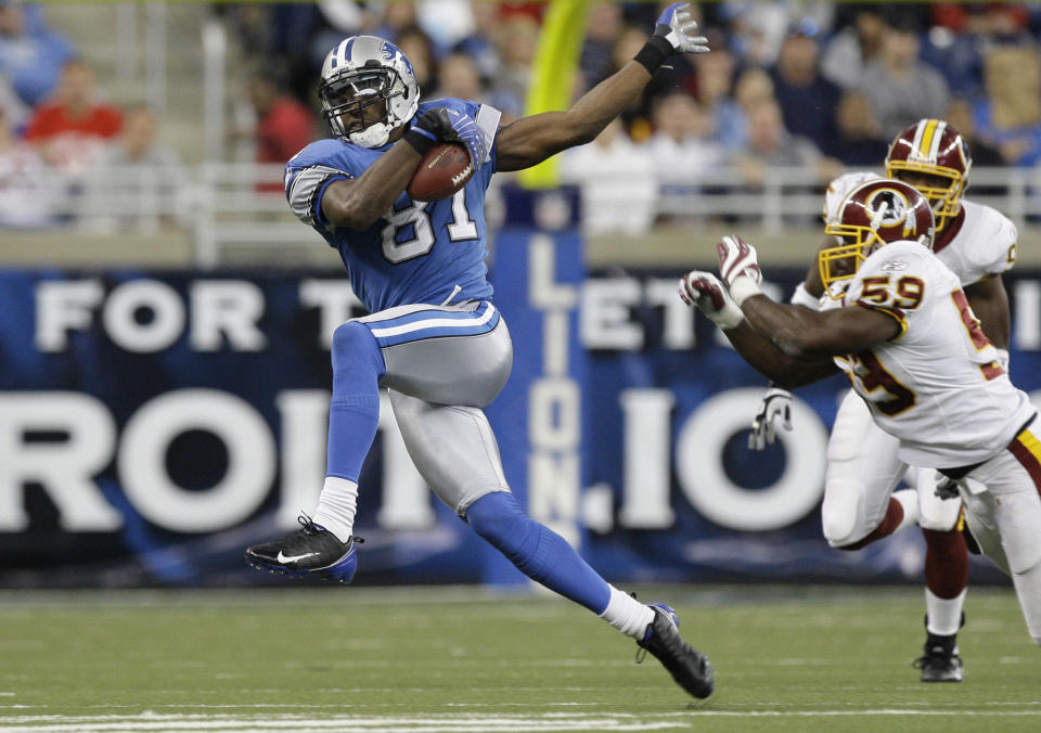 FILE - In this Oct. 26, 2008, file photo, Detroit Lions wide receiver Calvin Johnson makes catch against the Washington Redskins in the fourth quarter of an NFL football game in Detroit. Calvin Johnson is simply in awe that he will soon join Jim Brown and Gale Sayers as Pro Football Hall of Famers inducted at the age of 35 years old or younger. (AP Photo/Paul Sancya, File)