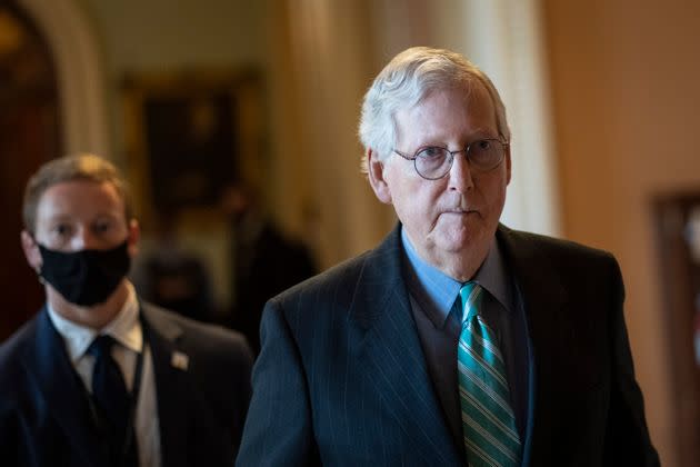Senate Minority Leader Mitch McConnell (R-Ky.) returns to his office after a  meeting with Senate Republicans on Thursday as they neared a deal to temporarily raise the debt ceiling. (Photo: Drew Angerer via Getty Images)