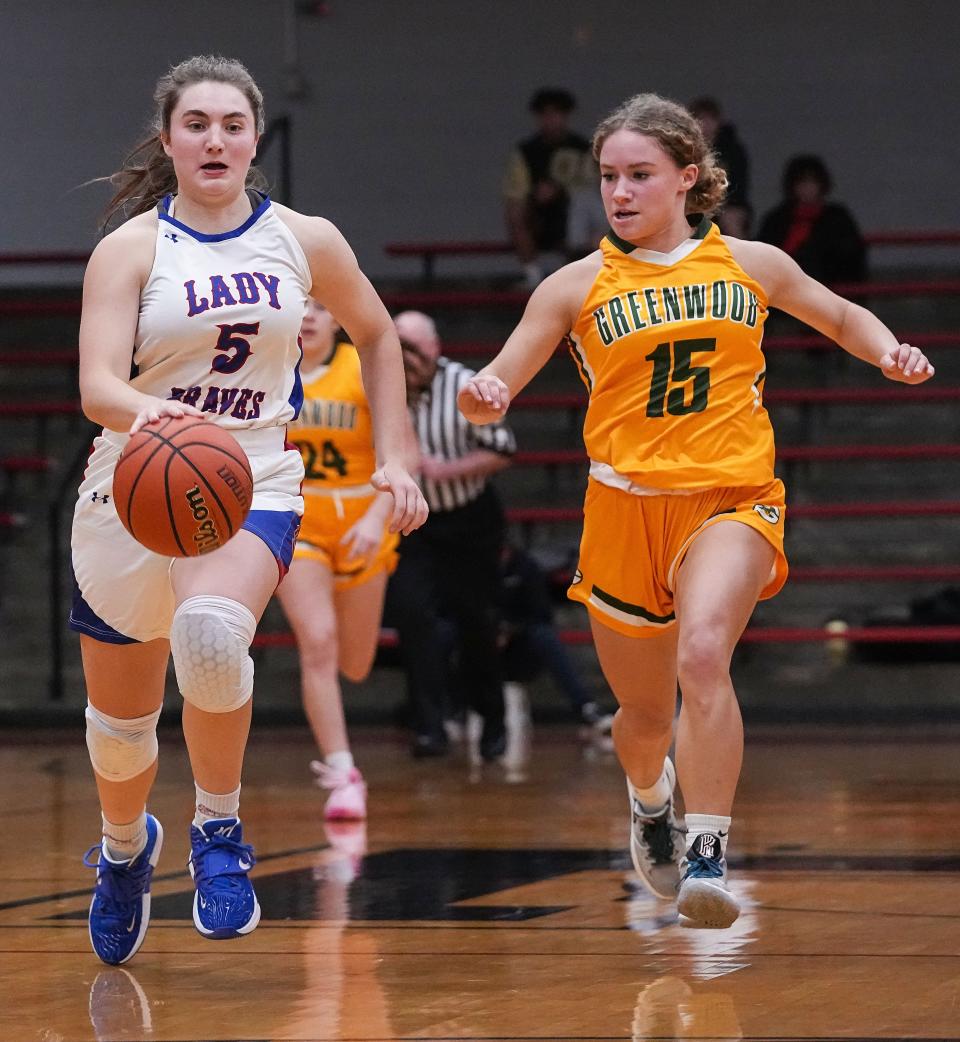 Indian Creek guard Lauren Foster (5) rushes up the court against Greenwood Woodmen guard Emily Metzger (15) on Thursday, Nov 17, 2022 at Edinburgh High School in Edinburgh. Indian Creek defeated the Greenwood Woodmen, 38-19. 