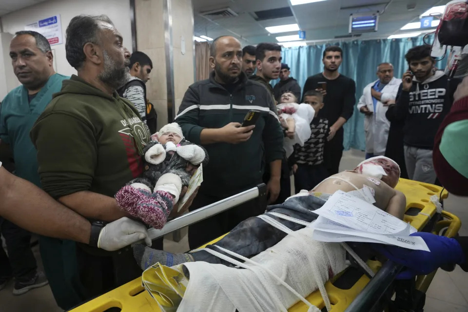 Palestinian children wounded in the Israeli bombardment of the Gaza Strip are brought to the hospital in Deir al Balah, Gaza Strip, on Monday, Dec. 11, 2023. (AP Photo/Adel Hana)