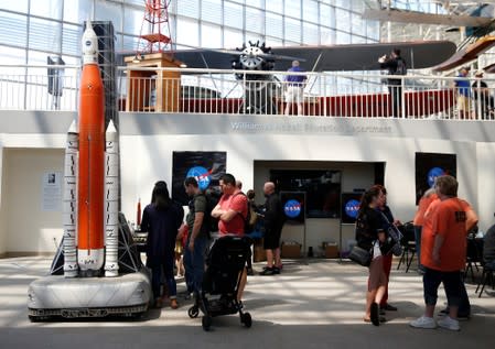 People walk through space-themed activity stations on the 50th anniversary of the Apollo 11 moon landing at the Museum of Flight in Seattle