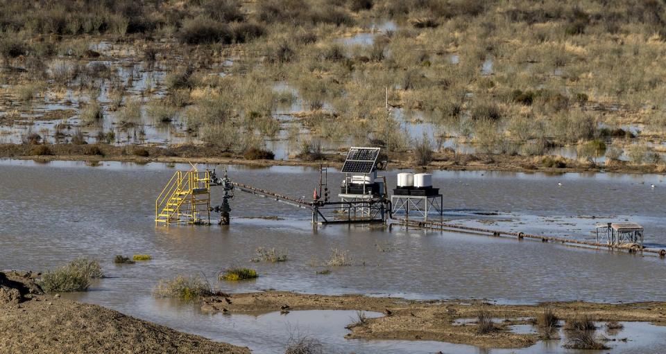 Mining infrastructure in the Lake Eyre Basin, here recently flooded, threatens the pristine natural wonder. Doug Gimesy