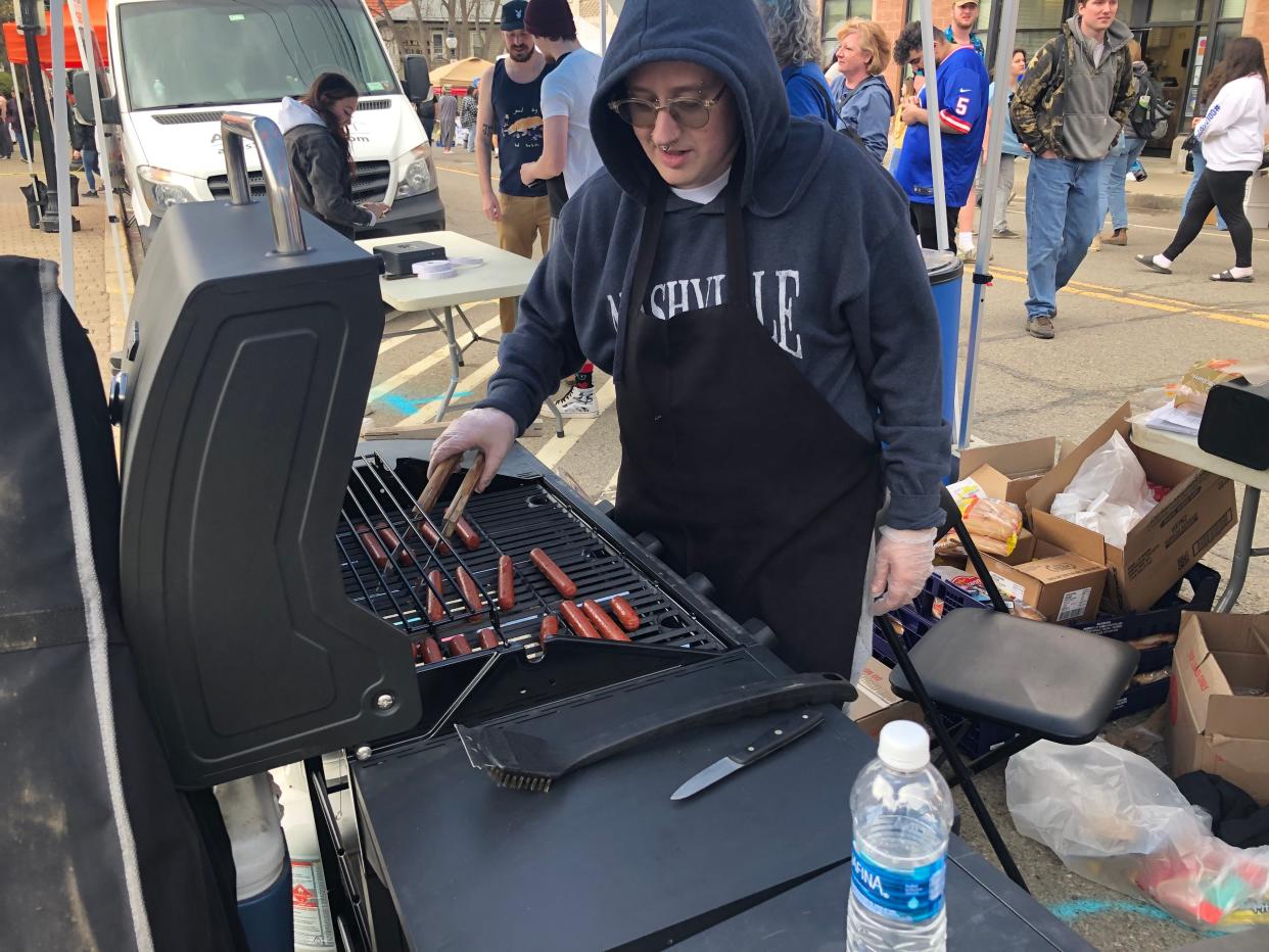 This is what it's all about. A grill master cooks up some hot dogs in Alfred during Hot Dog Day in 2023. Proceeds from the event benefit community organizations.