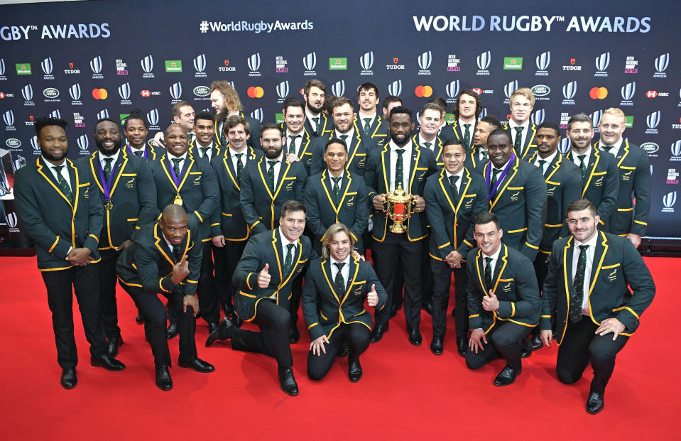 South Africa's captain Siya Kolisi, center, holding the Webb Ellis Cup and teammates pose for a group photo, ahead of the World Rugby Awards ceremony in Tokyo, Sunday, Nov. 3, 2019. (Tsuyoshi Ueda/Kyodo News via AP)