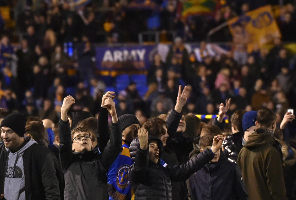 Shrewsbury Town fans celebrate at the end of the English FA Cup fourth round soccer match between Shrewsbury Town and Liverpool at the Montgomery Waters Meadow in Shrewsbury, England, Sunday, Jan. 26, 2020. (AP Photo/Rui Vieira)